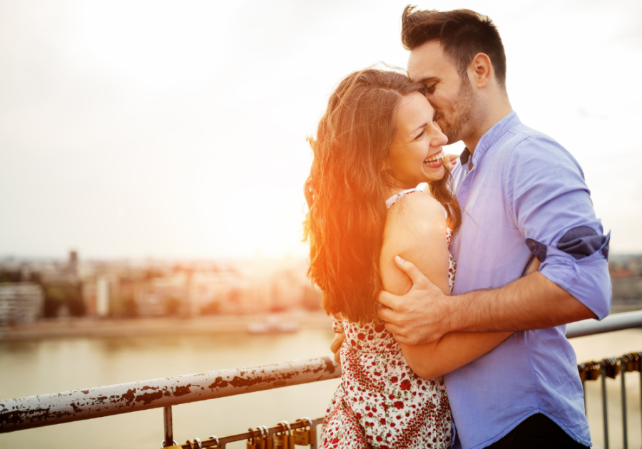 couple kissing on dock near water Taurus Man and Gemini Woman Compatibility 