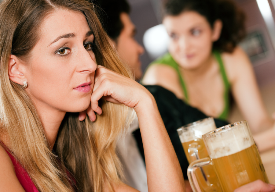 woman sitting alone beside man Signs Your Boyfriend Likes His Female Friend