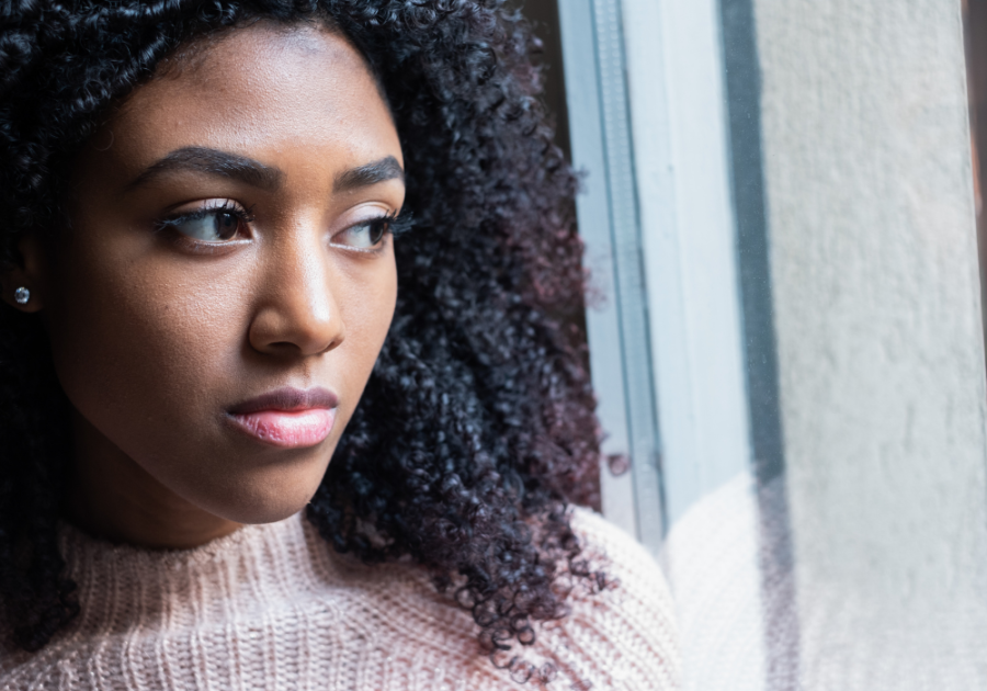 woman looking out window Psychological Effects of Being Single Too Long