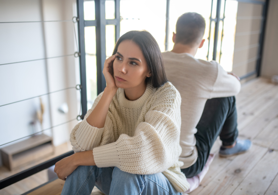 couple sitting back to back on floor Hysterical Bonding