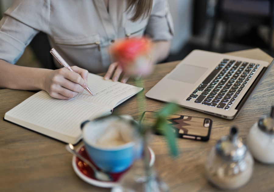 woman sitting at table writing on paper Missing You Poems