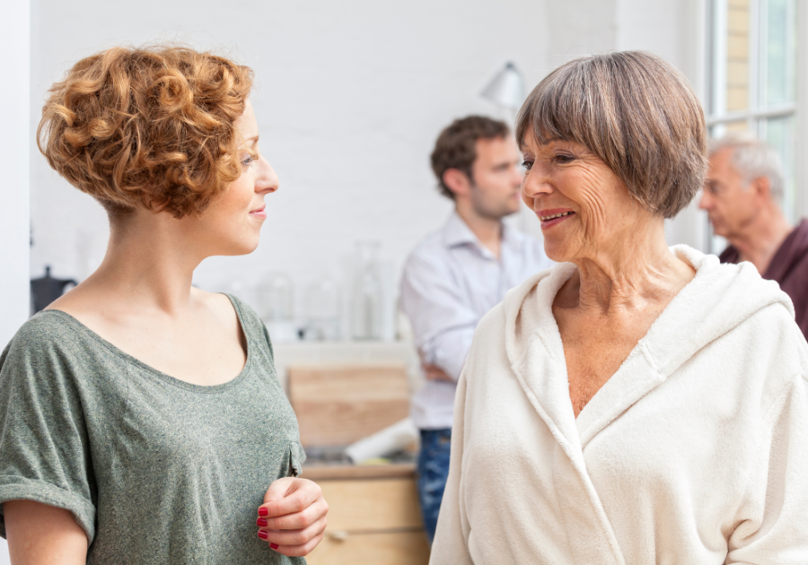 older woman talking to younger woman Signs Your Husband Puts His Family First