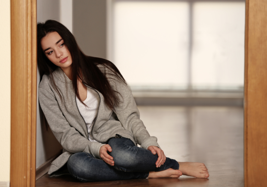 woman sitting on floor sad feeling