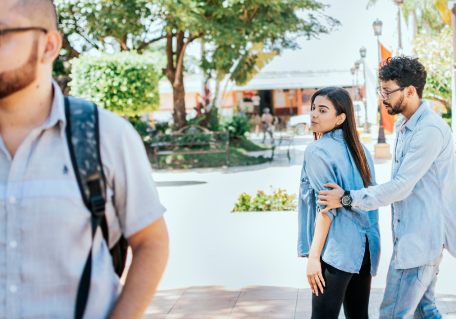 woman being consoled by man outdoors trick questions to ask your girlfriend to see if she's cheating