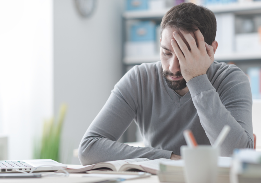 man sitting a desk dejected feeling defeated