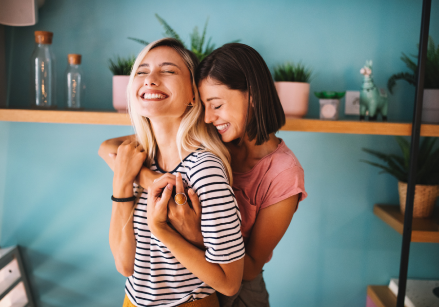 women hugging laughing Unconsciously Saying "I Love You