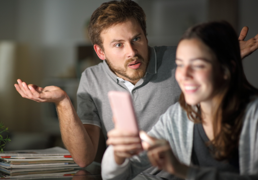 man frustrated with woman on phone Spouse Doesn't Want to Do Anything with You