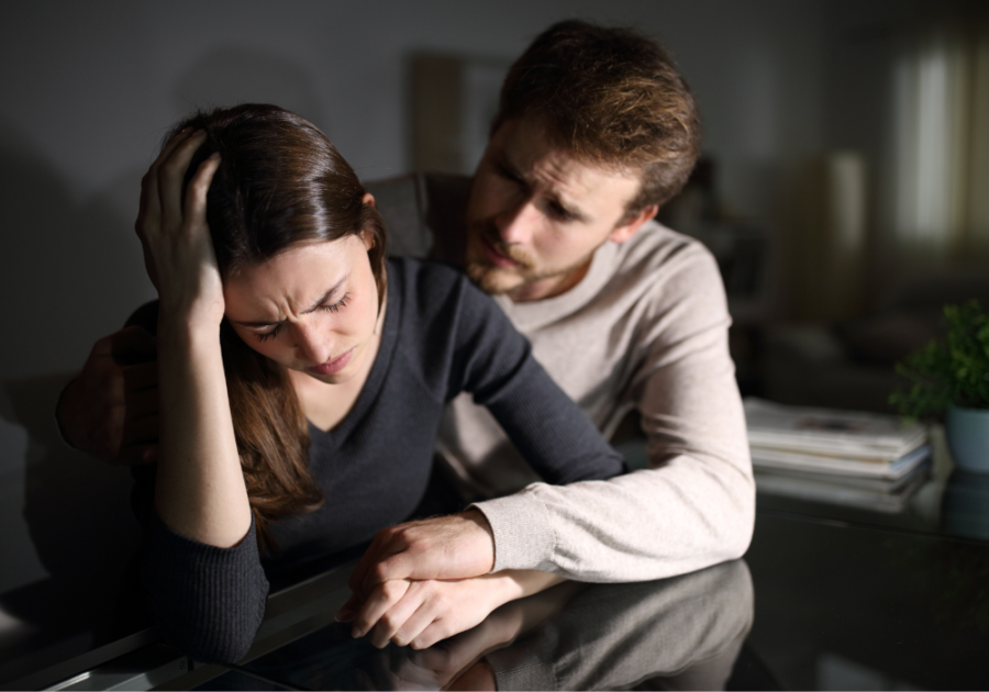 man consoling woman girlfriend wets the bed