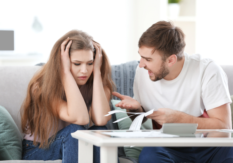 woman holding her head sitting beside man Things Your Partner Should Never Say to You