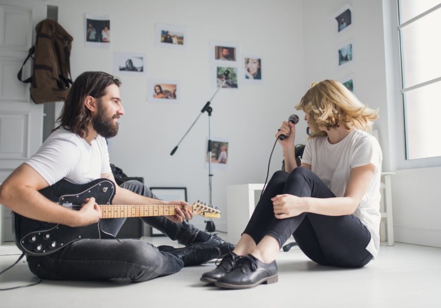 couple sitting on floor playing music together Aesthetic Attraction 