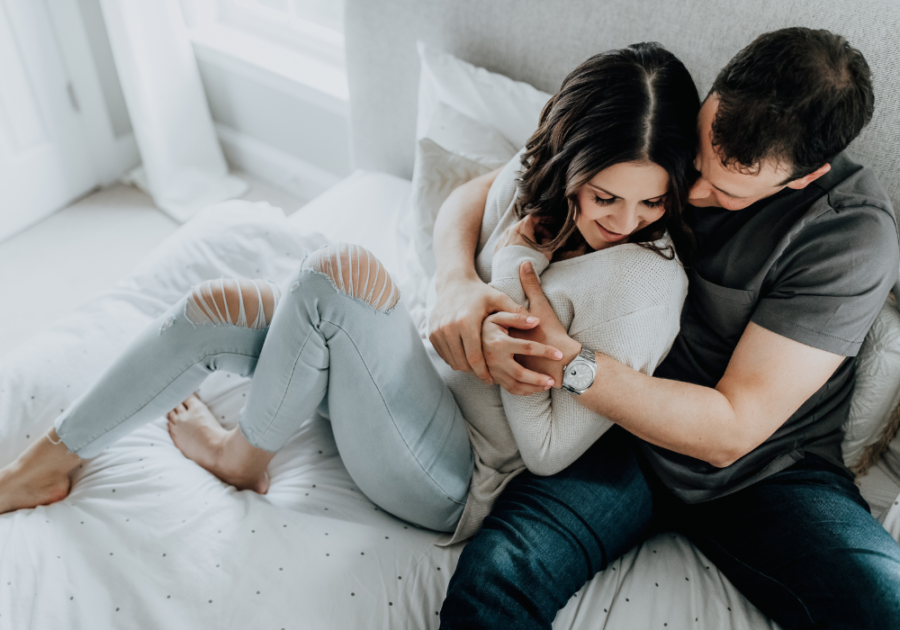 couple sitting on sofa hugging Casual Relationship is Getting Serious