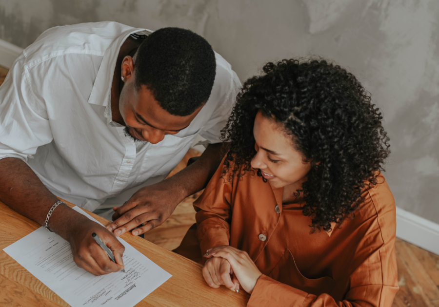 couple sitting at table writing Relationship Contract template