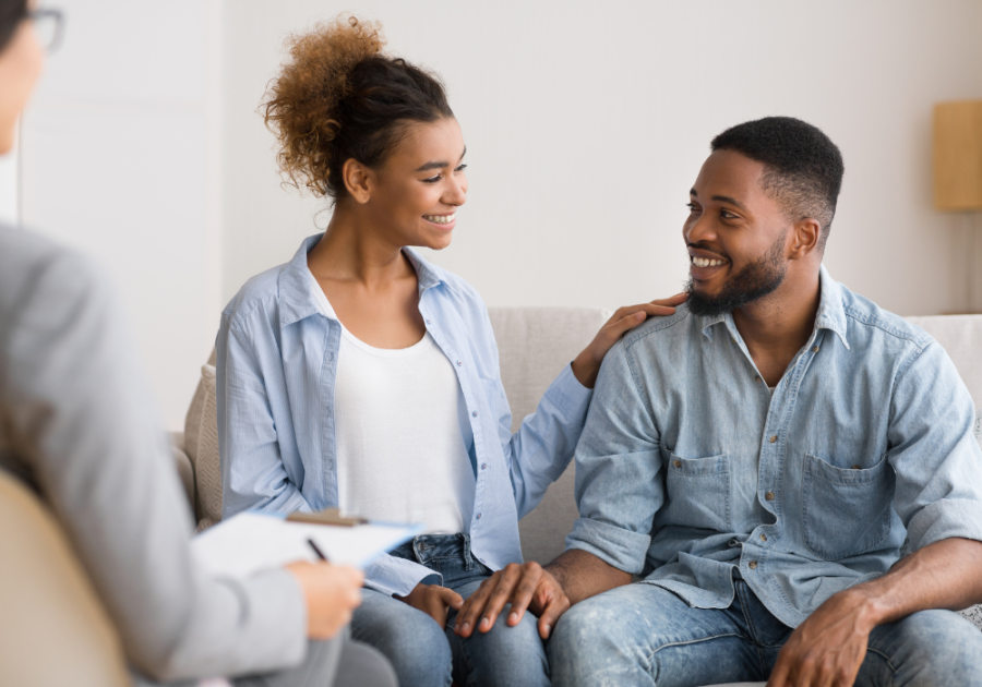 couple sitting on sofa smiling with counselor Fix a Toxic Relationship