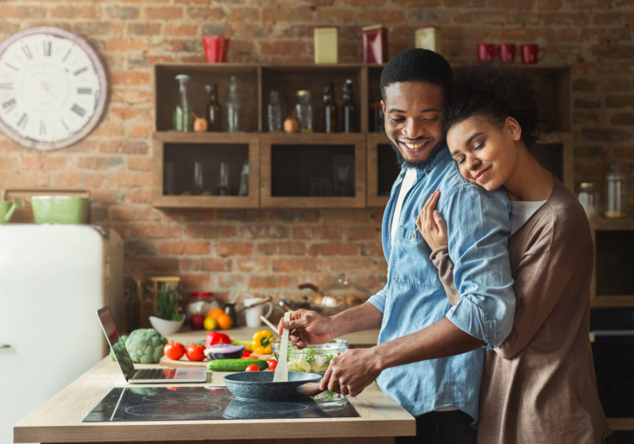 couple hugging in kitchen cooking how to be a better husband