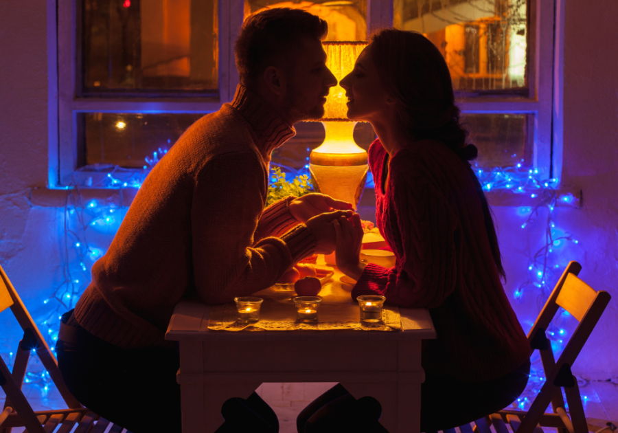 couple kissing at table Signs a Taurus Man is Sexually Attracted to You