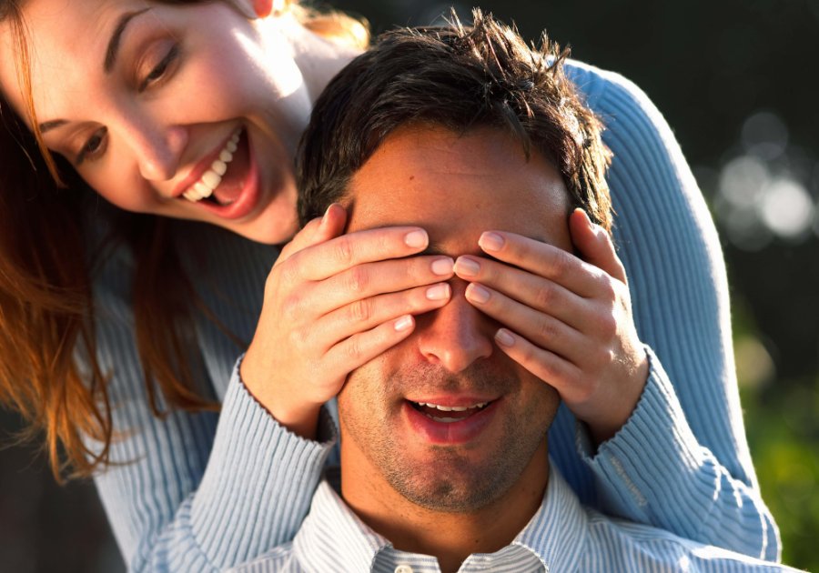 woman covering man's eyes pranks to do on your boyfriend