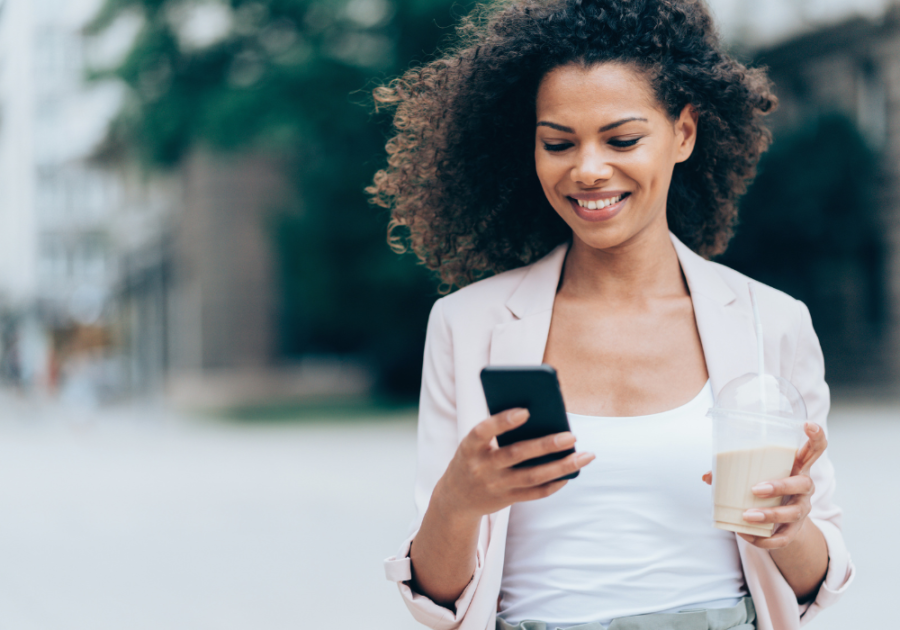 woman smiling reading phone walking Birthday Paragraphs for Your Best Friend