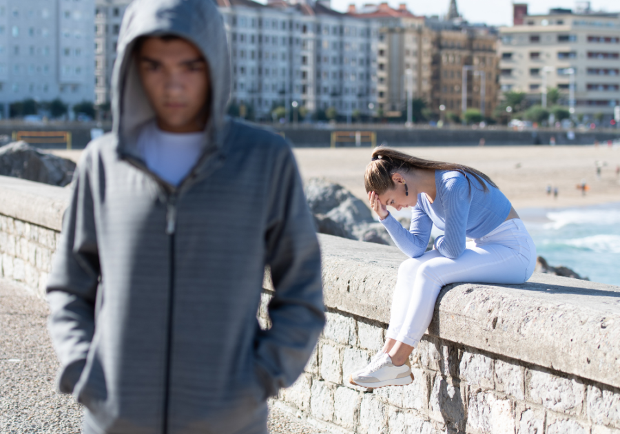 man turning his back to woman sitting on wall It's Not You It's Me