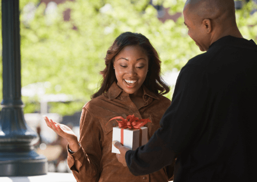 man giving woman a gift gold personality traits